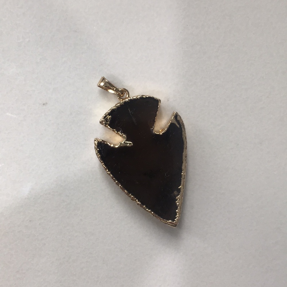 black and gold arrowhead charm